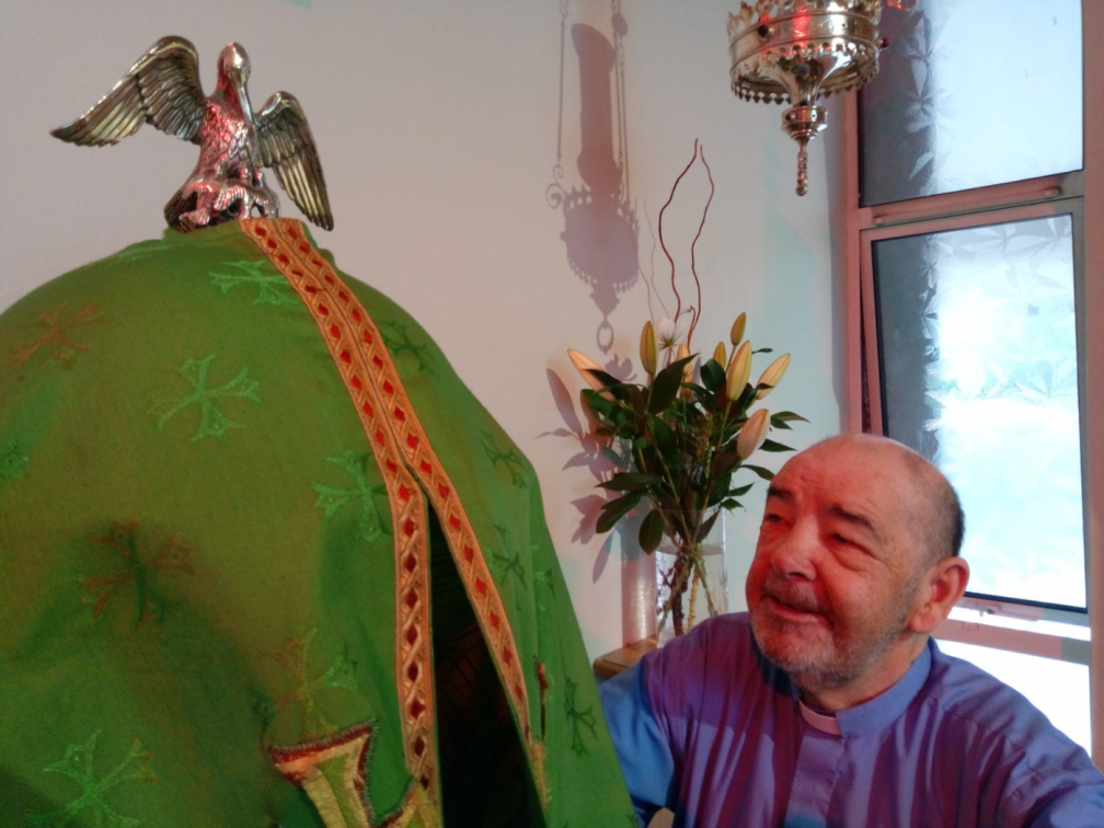 Parish priest Fr. Tim McGrath and the pelican-topped tabernacle