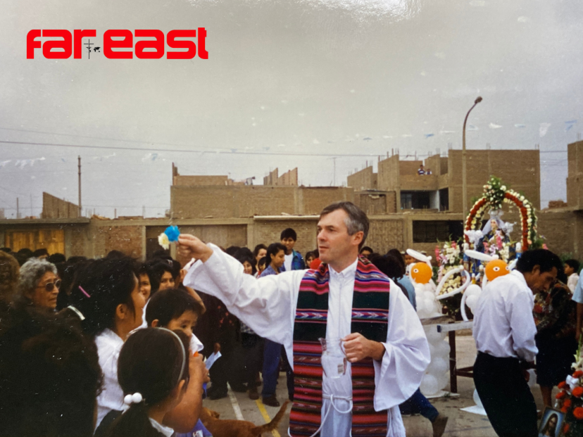 Fr. John Boles blessing the people after an outside Mass in a shanty town near Lima, Per in 1998.