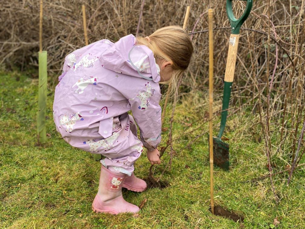Emma's eldest daughter plants a tree sapling in the grounds of the Columban Solihull House in Britain during a tree planting day for the community in February 2025