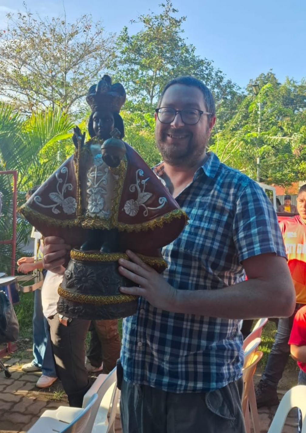 James Trewby with a statue of the child Jesus, a during a celebration of the Santo Niño