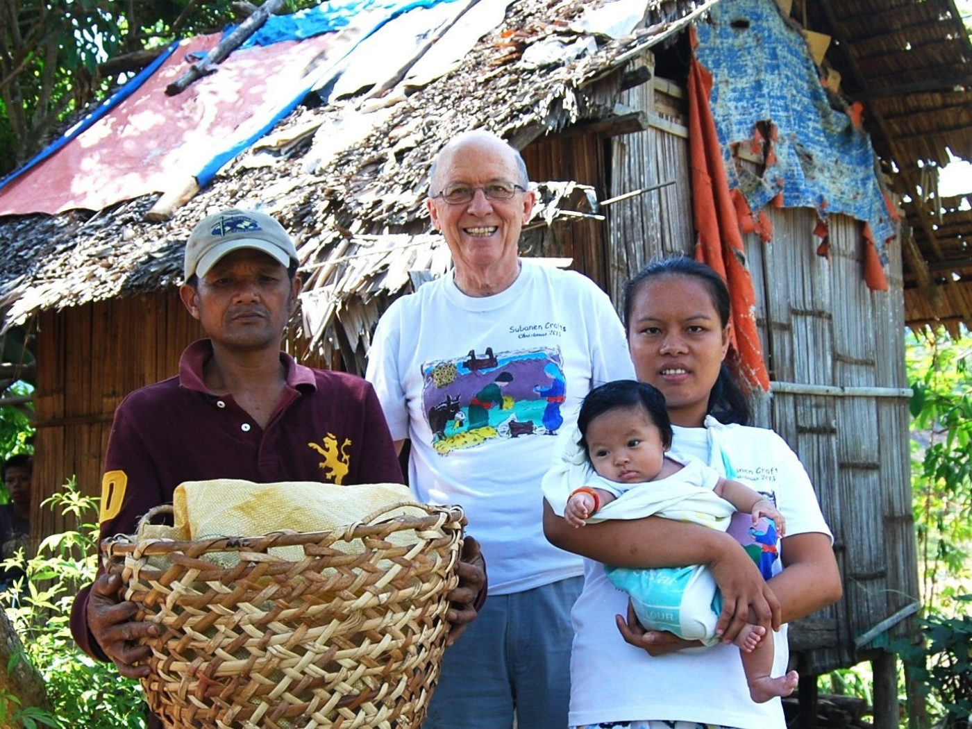 A Subanen family outside their home alongside Fr. Vincent Busch. Notice the man's calloused hands, reflecting a life of hard work