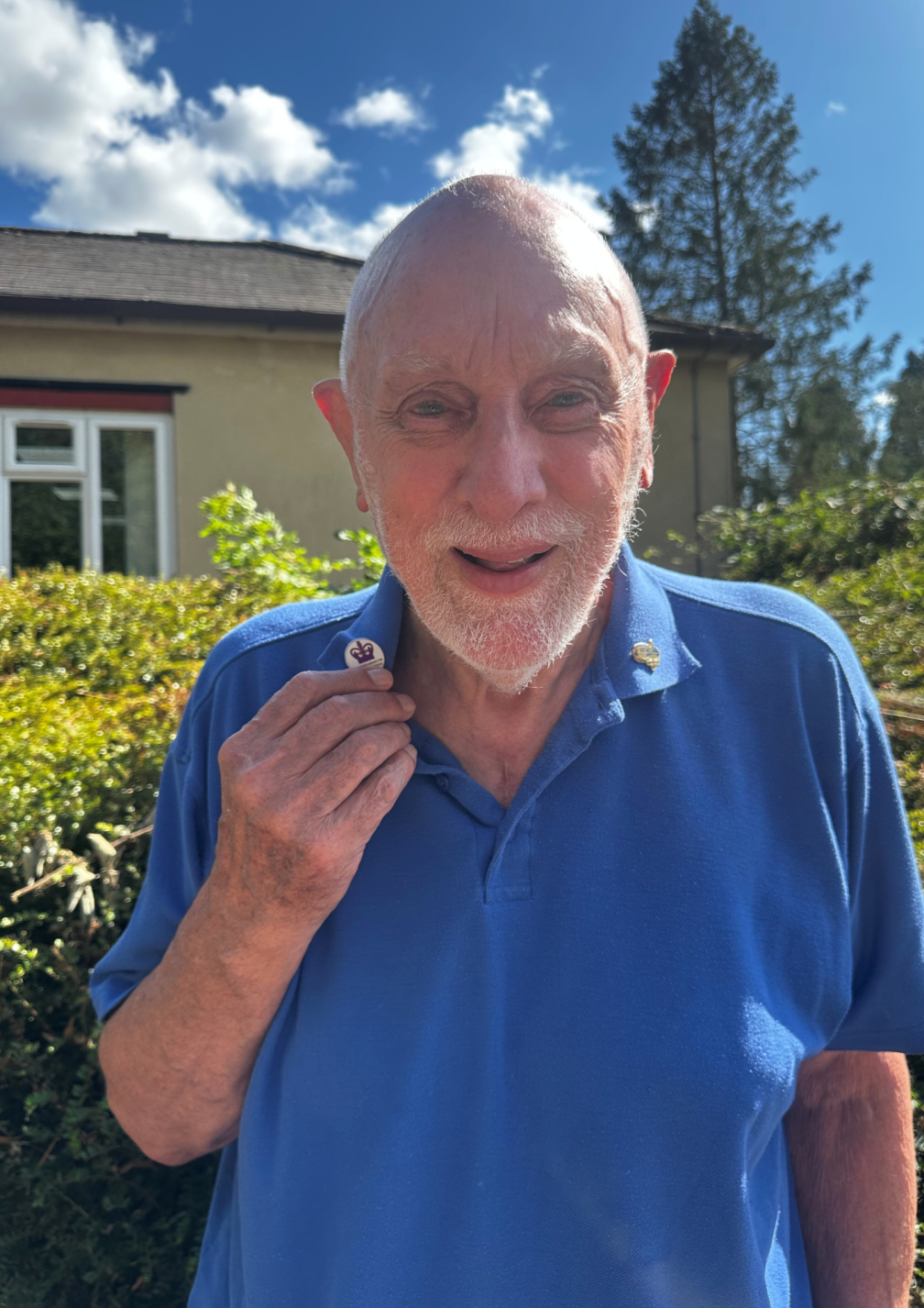 Fr. Ray Collier with his enamel Kings Award pin badge