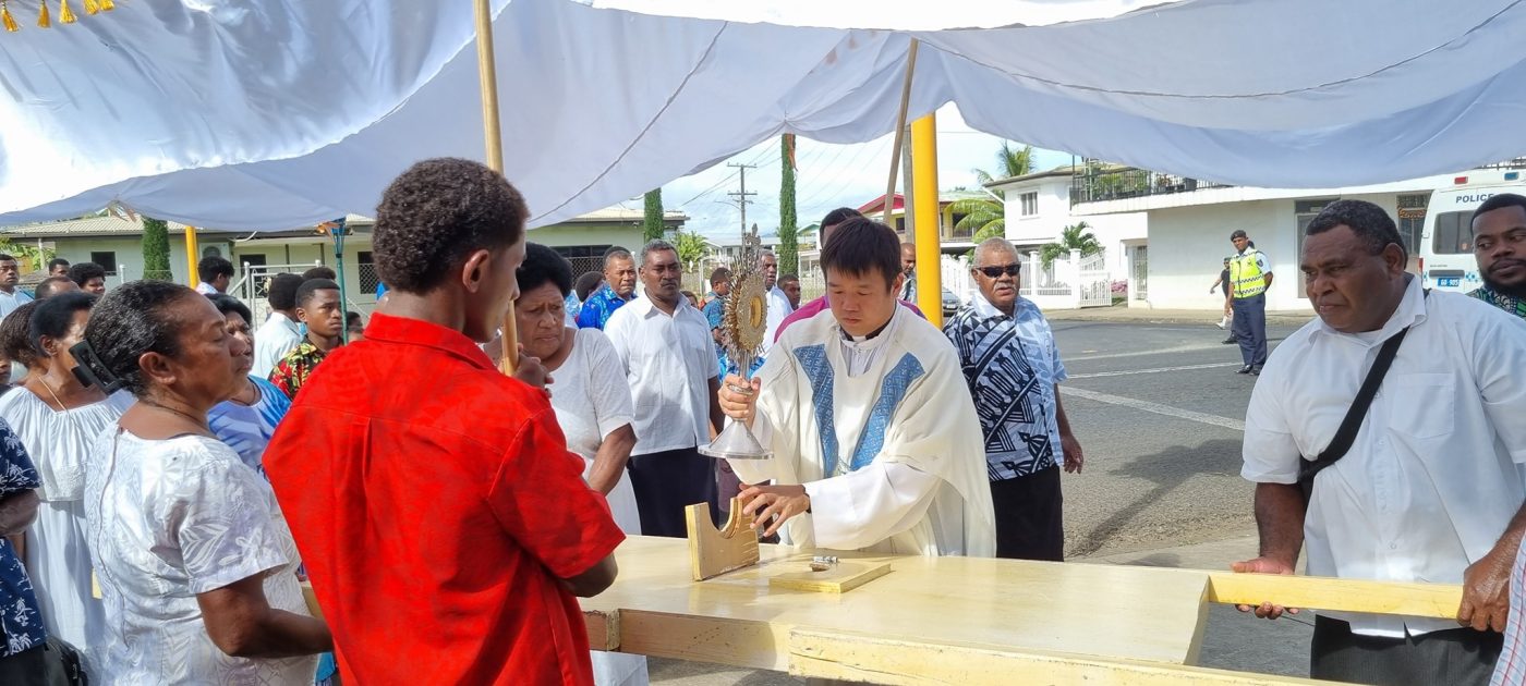 Fr. Jung with parishioners during the Corpus Christi Sunday procession