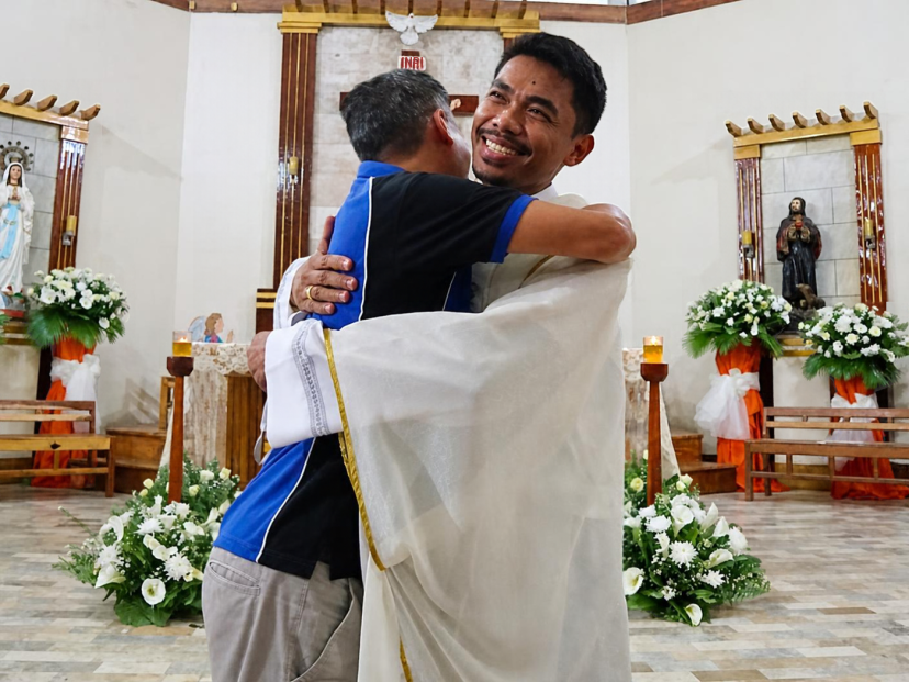 Bernie warmly embraces Columban Fr. Jerry Lohera, after his ordination in June 2022